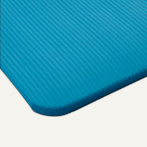 Close-up of a blue textured yoga mat corner.